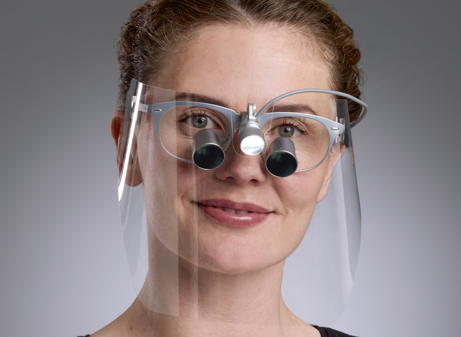 Female dentist wears Visionshield to protect her dental loupes Galilean HD in Icon frame v2